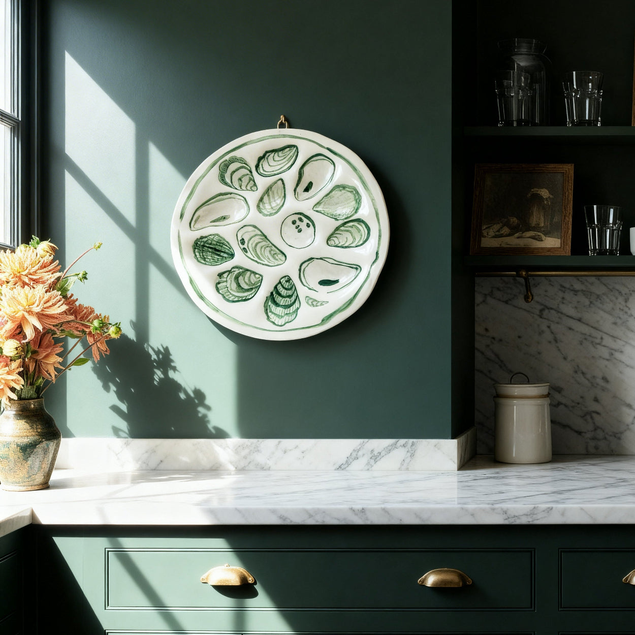kitchen with green cabinets, marble countertop, and decorative wall art.