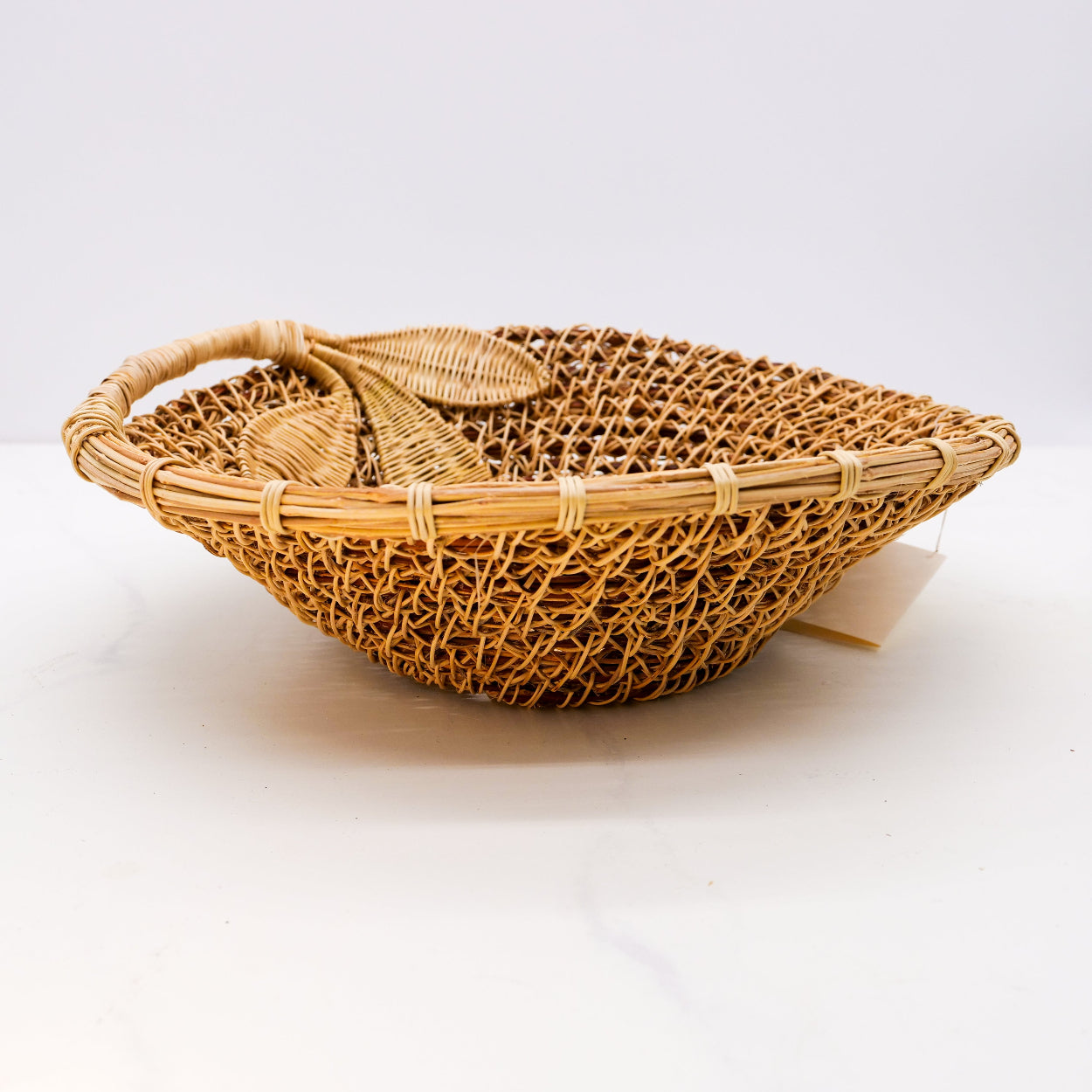 Handmade oval honeysuckle basket with a leaf design.