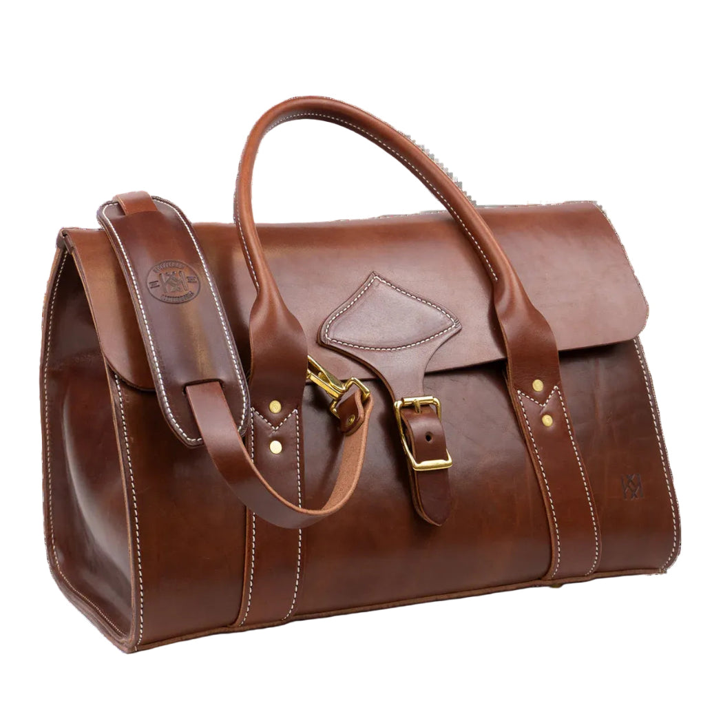 Brown leather weekender bag with brass hardware.