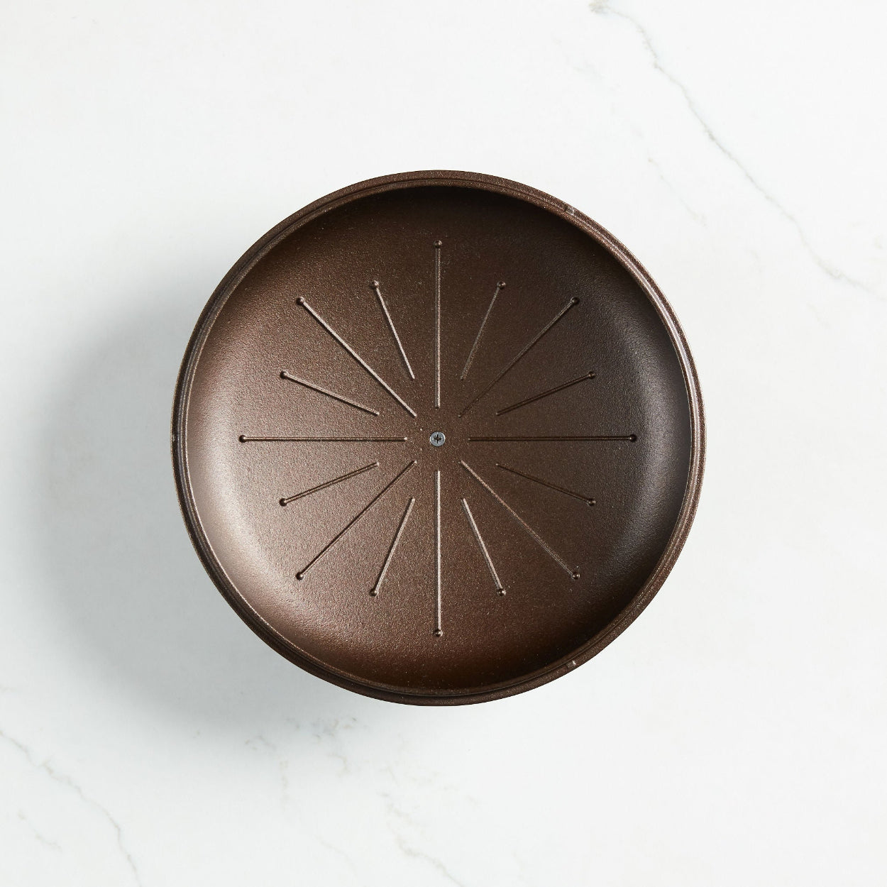 Lid of a Smithey Cast Iron Dutch Oven, showing the channels used to capture moisture.