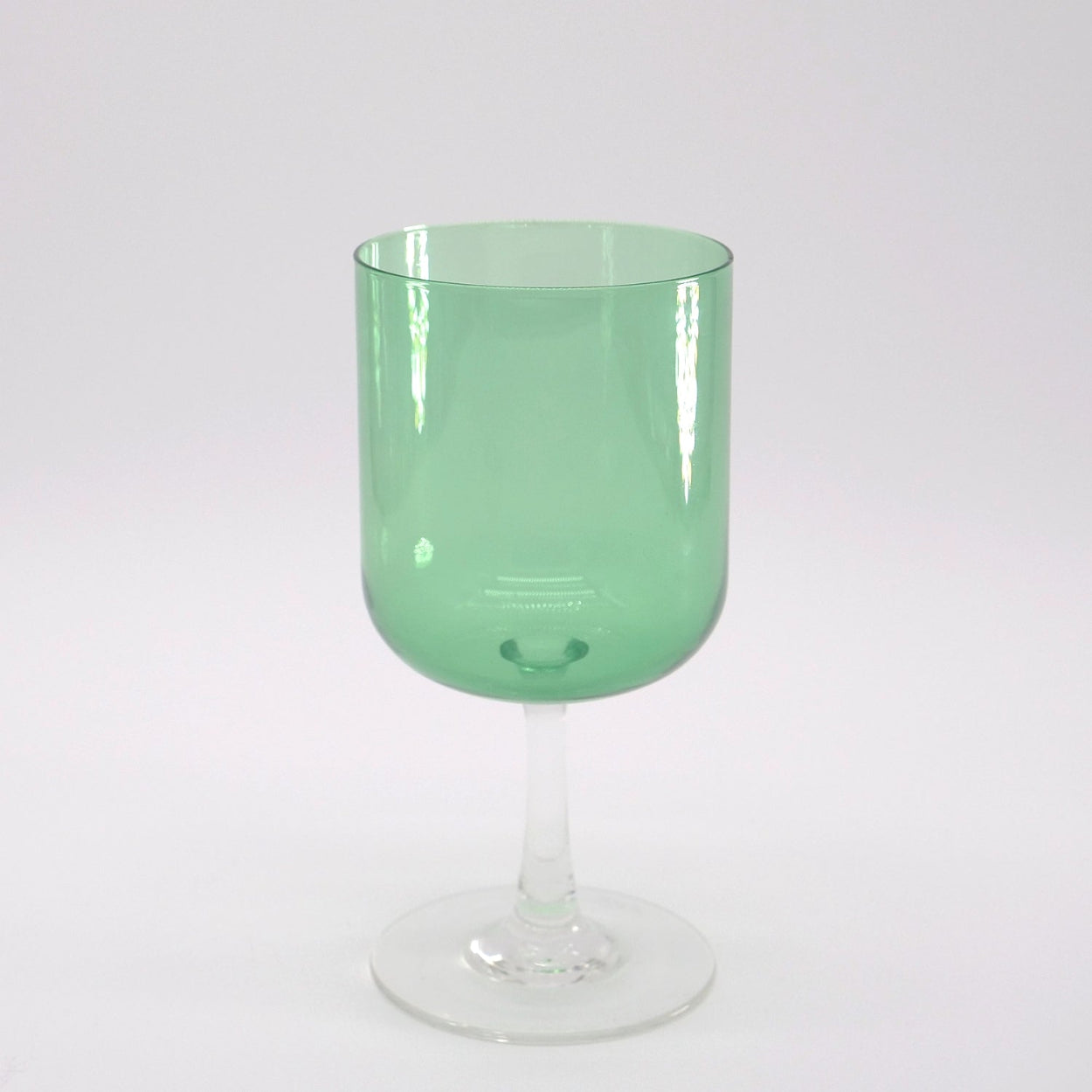 A hand-blown green-colored stemware glass with a clear stem and base, displayed against a white background.