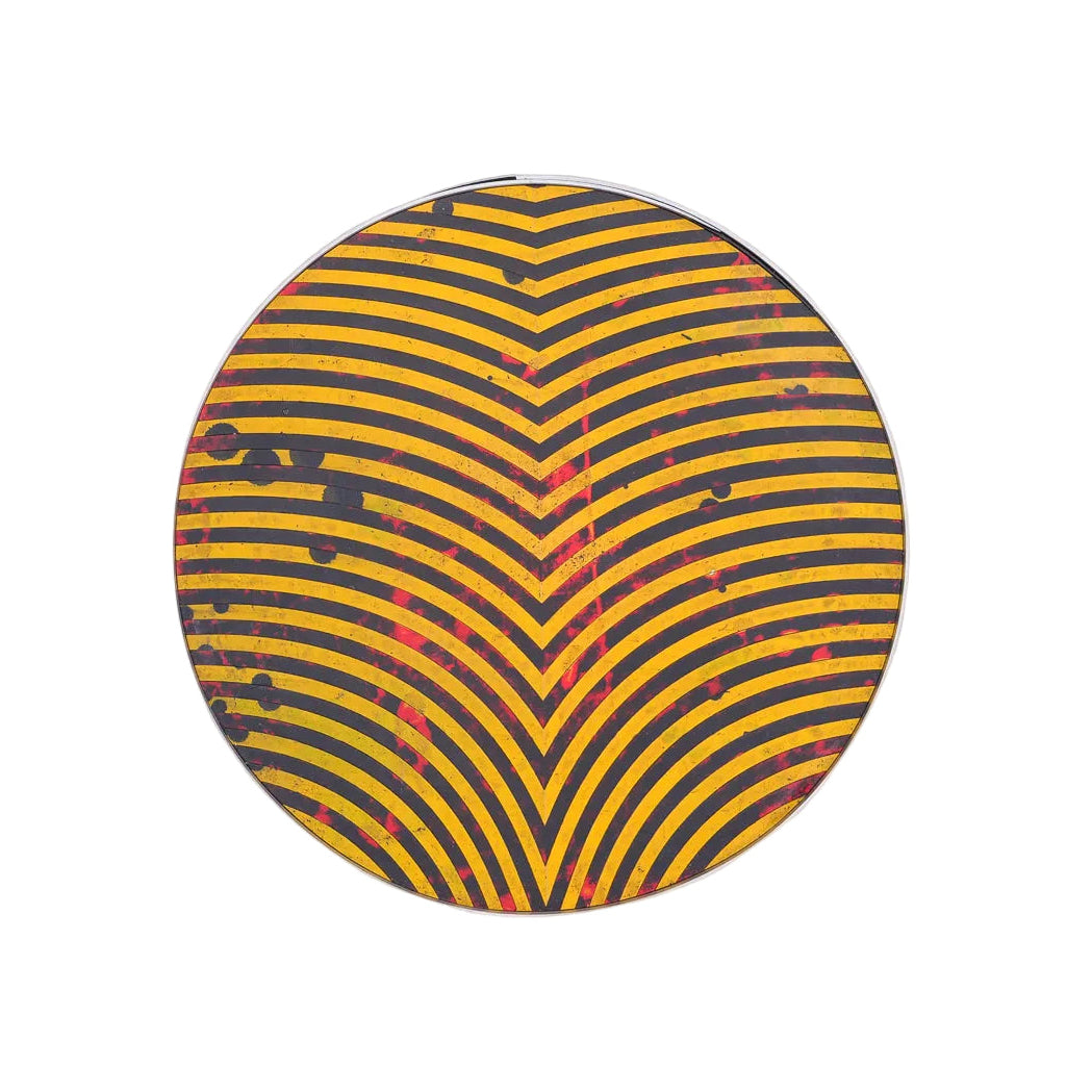 Round decorative tray by Robert Patterson with yellow and black chevron pattern on a white background