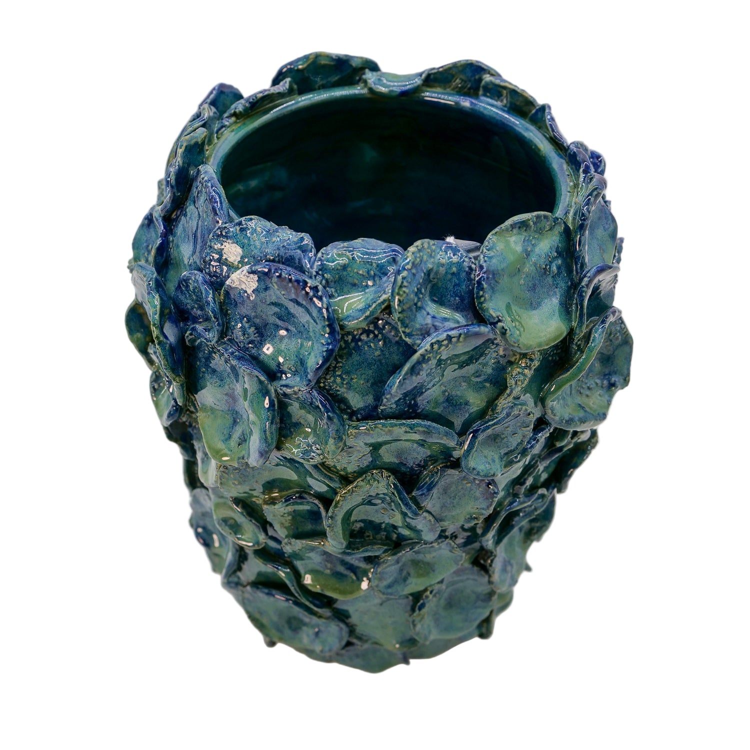 Blue ceramic vase with textured surface on a white background